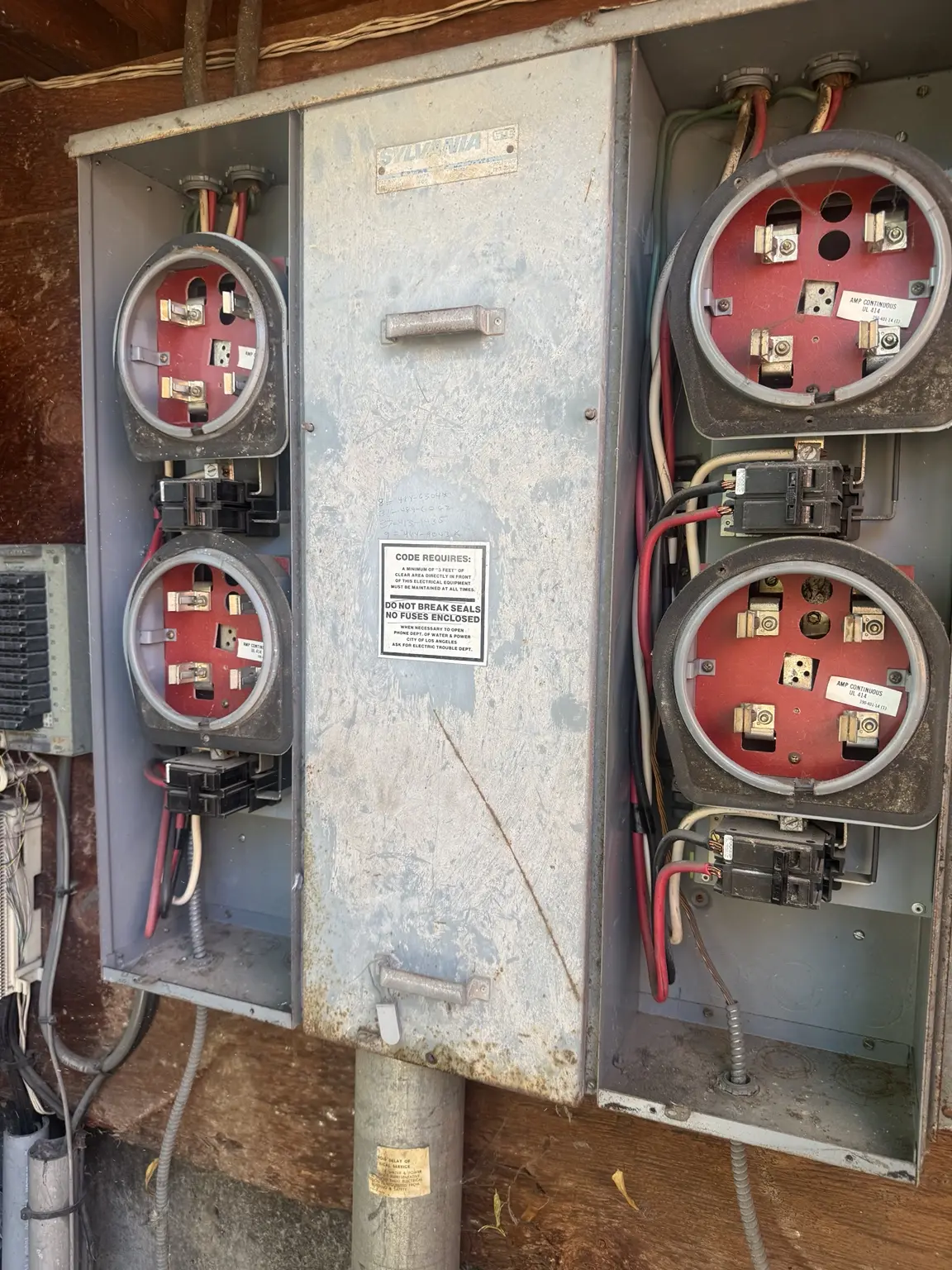 Existing multi-meter electrical equipment before replacement work