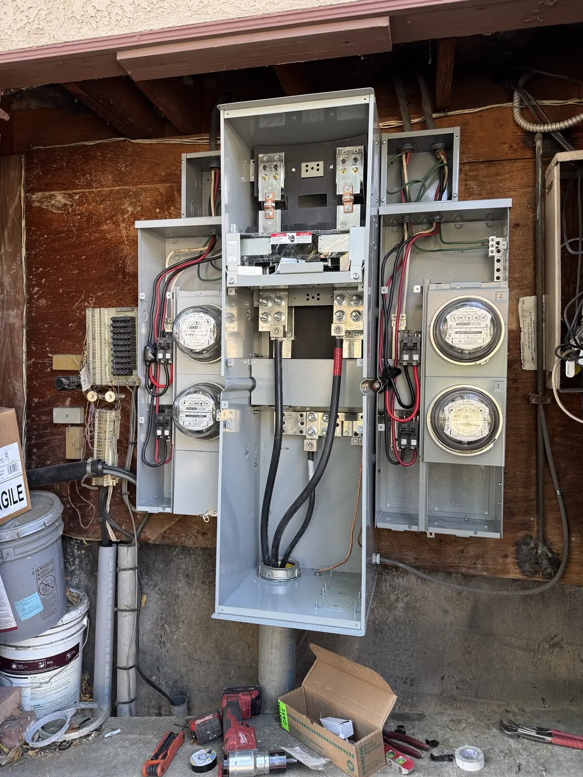 Replacement multi-meter electrical panel with covers removed during work in progress